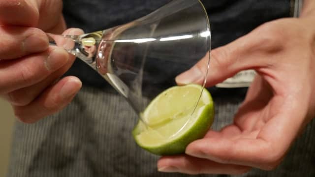 グラスのふちにライム果汁をつける画像。